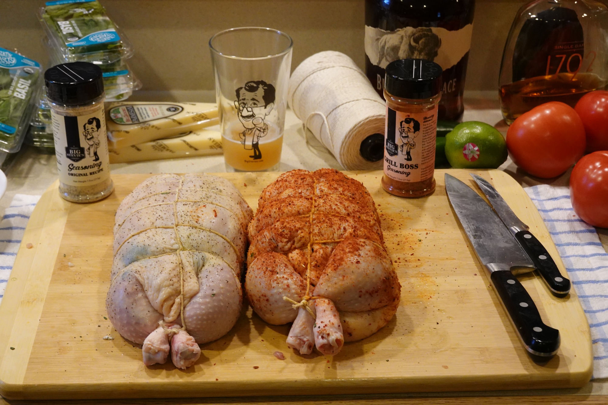 Two seasoned chickens on a cutting board